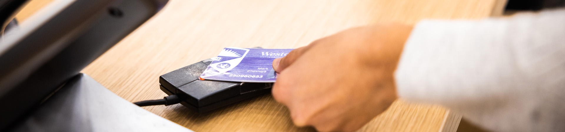 Student using their Western One card to check out a book
