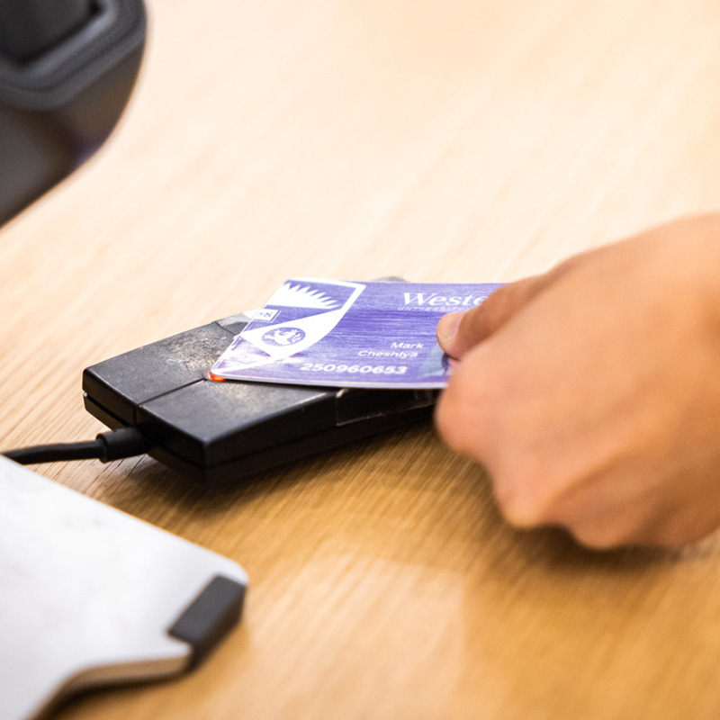 Student using their Western One card to check out a book
